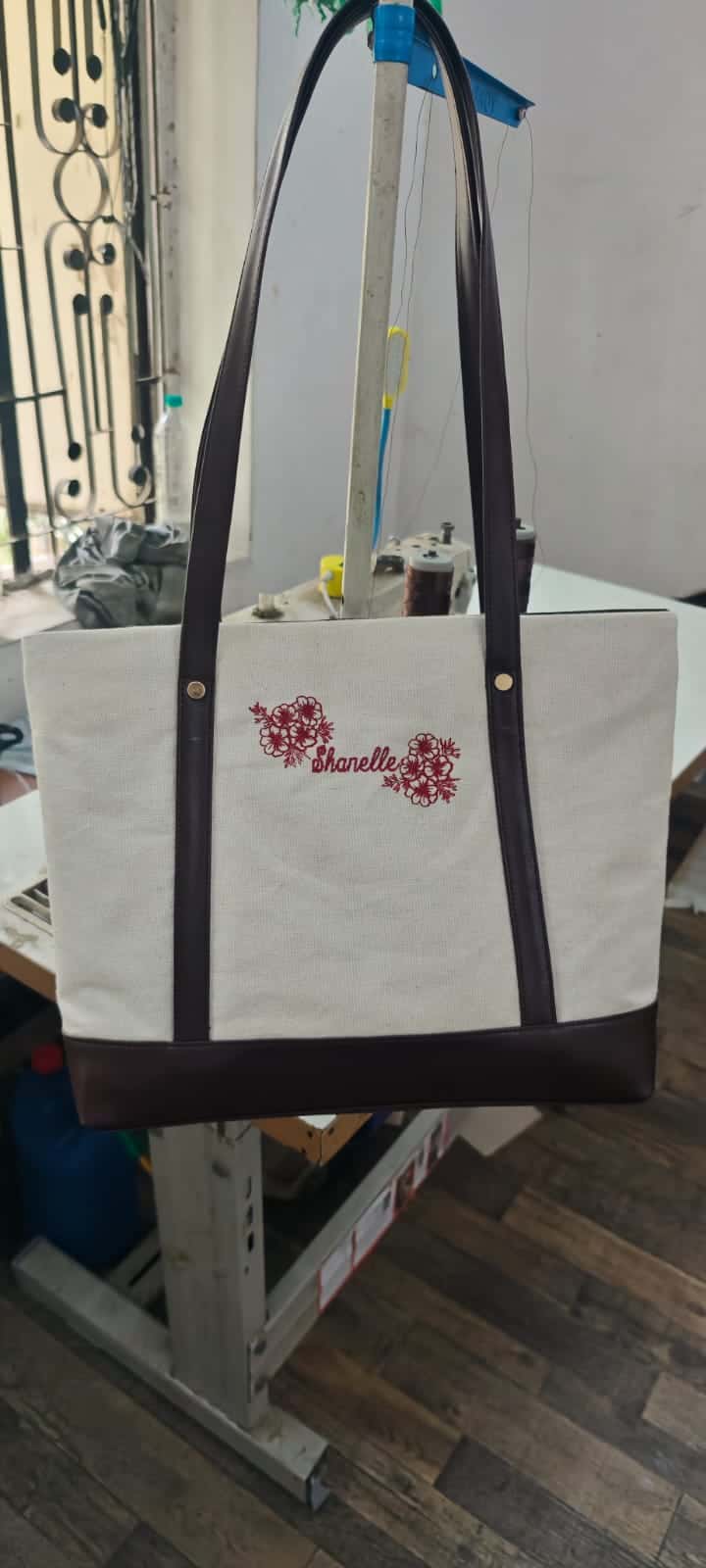 Cotton canvas tote with leather handles, side straps and base panel, embroidered with a customer's name, made by ABM Bags
