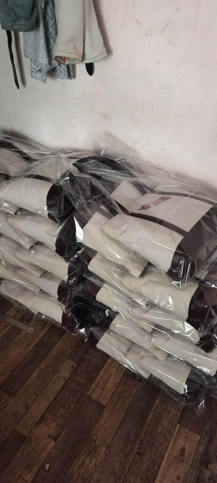 A bulk run of leather-trimmed canvas totes, bagged and stacked for dispatch at the ABM Bags unit in Hyderabad