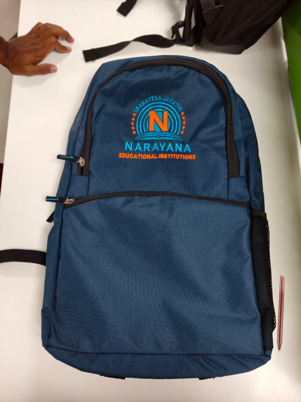 School backpack embroidered with a customer's crest, photographed at the workshop