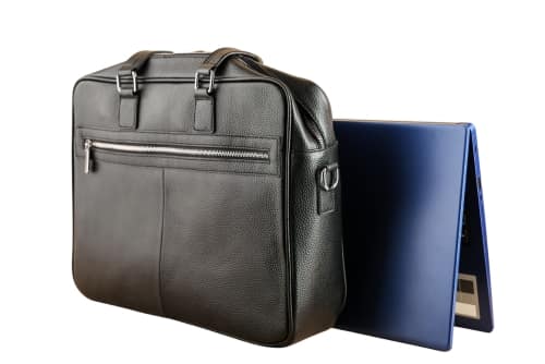 Leather laptop briefcase beside an open laptop